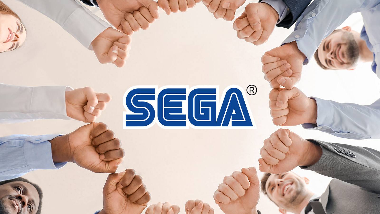 An image of a group of workers holding their fists in a circle, with the Sega logo in the middle.