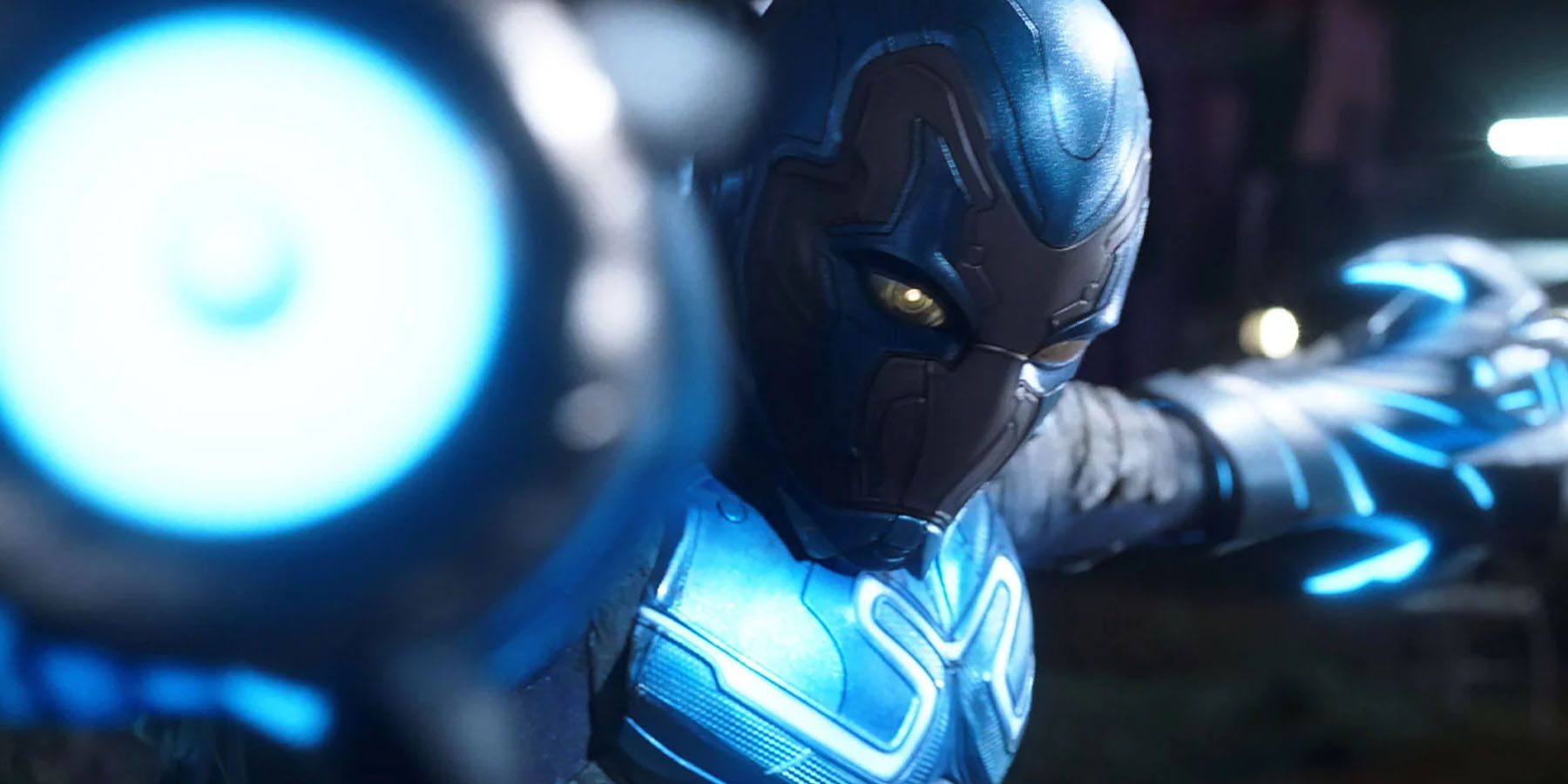A screenshot of Blue Beetle firing his cannons in the Blue Beetle movie.