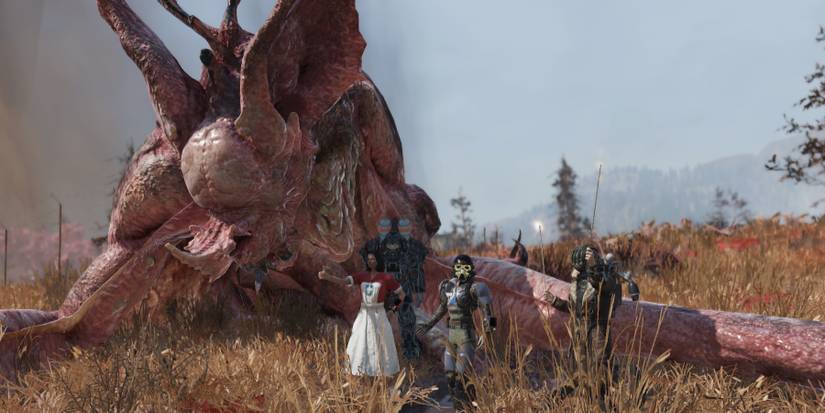 Fallout 76 Players Posing For Group Photo With Dead Scorchbeast Queen Raid Boss