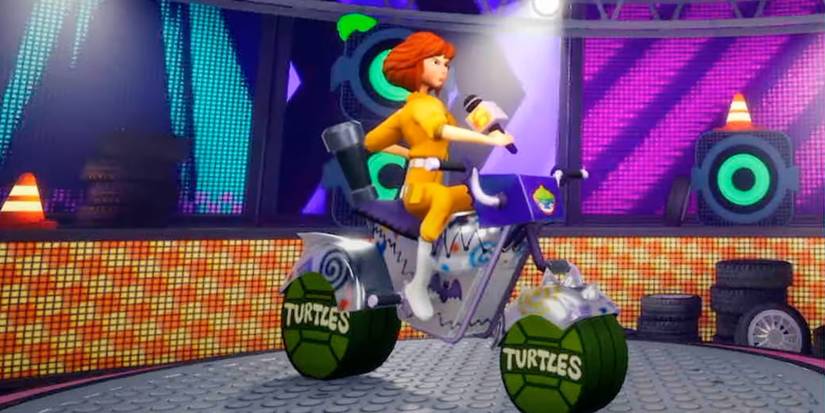 April holding a microphone on a turtles motorcycle