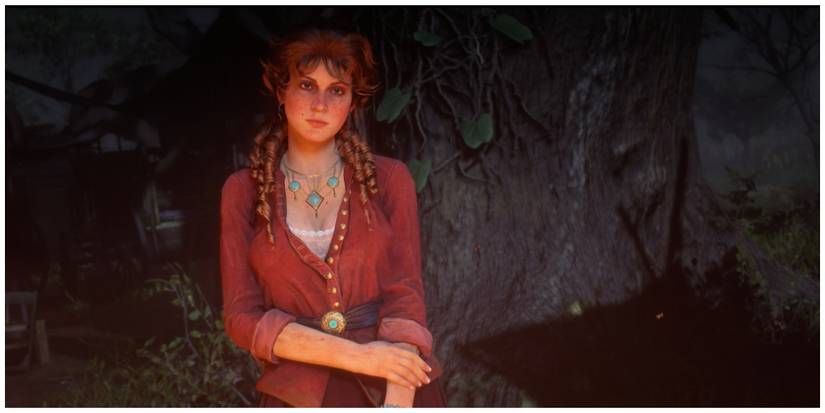 Mary-Beth sitting at a camp fire at night