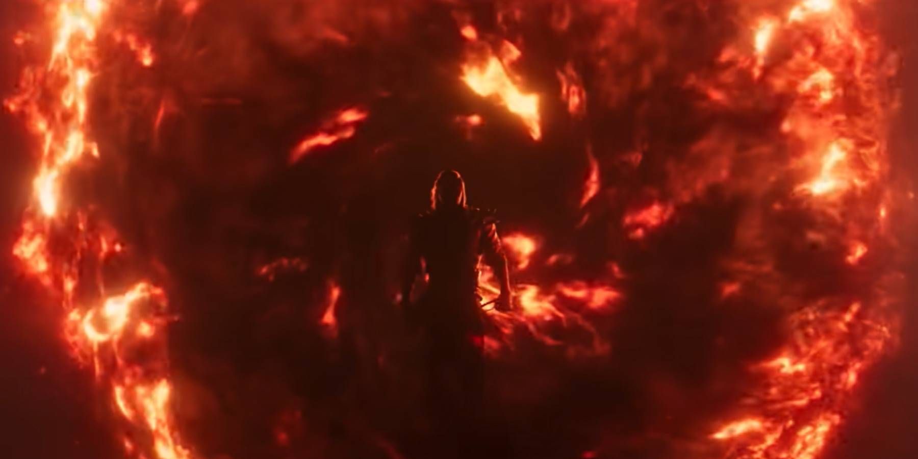 Silhouette of Shang Tsung emerging from a fiery portal in Mortal Kombat 1's trailer