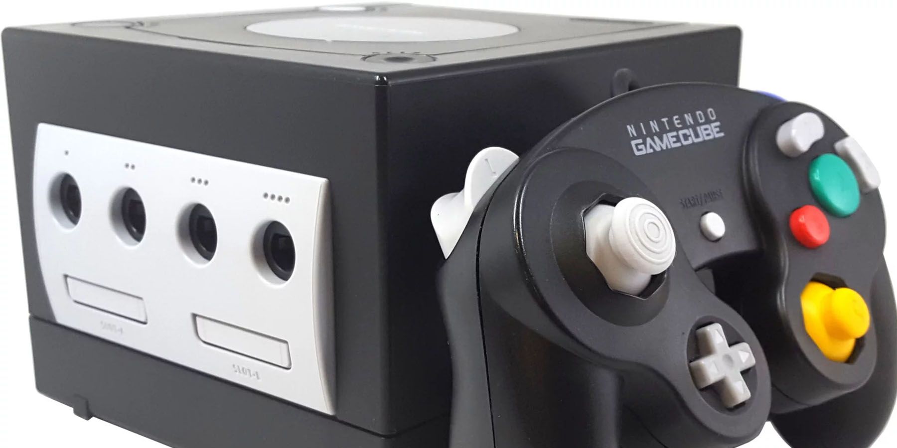 A photo of a black Nintendo GameCube and matching controller against a white background.