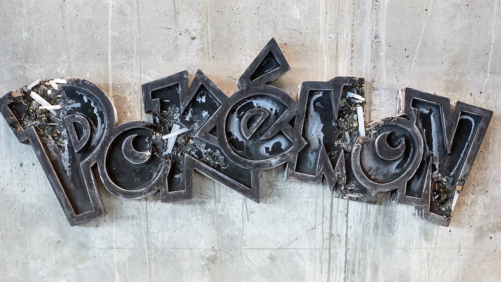 pokemon logo stone on wall