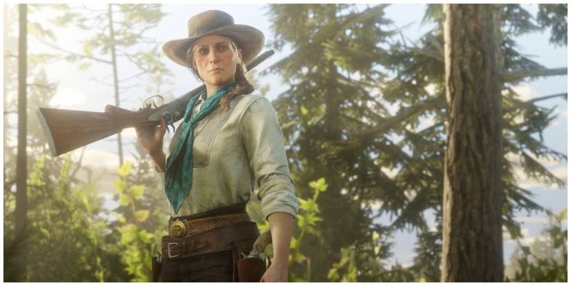Sadie Adler standing in the woods with gun