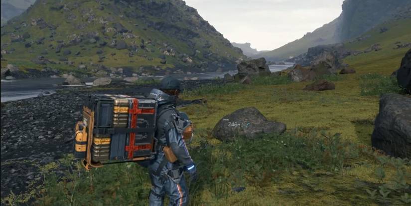 Sam With Heavy Cargo On His Back in Death Stranding