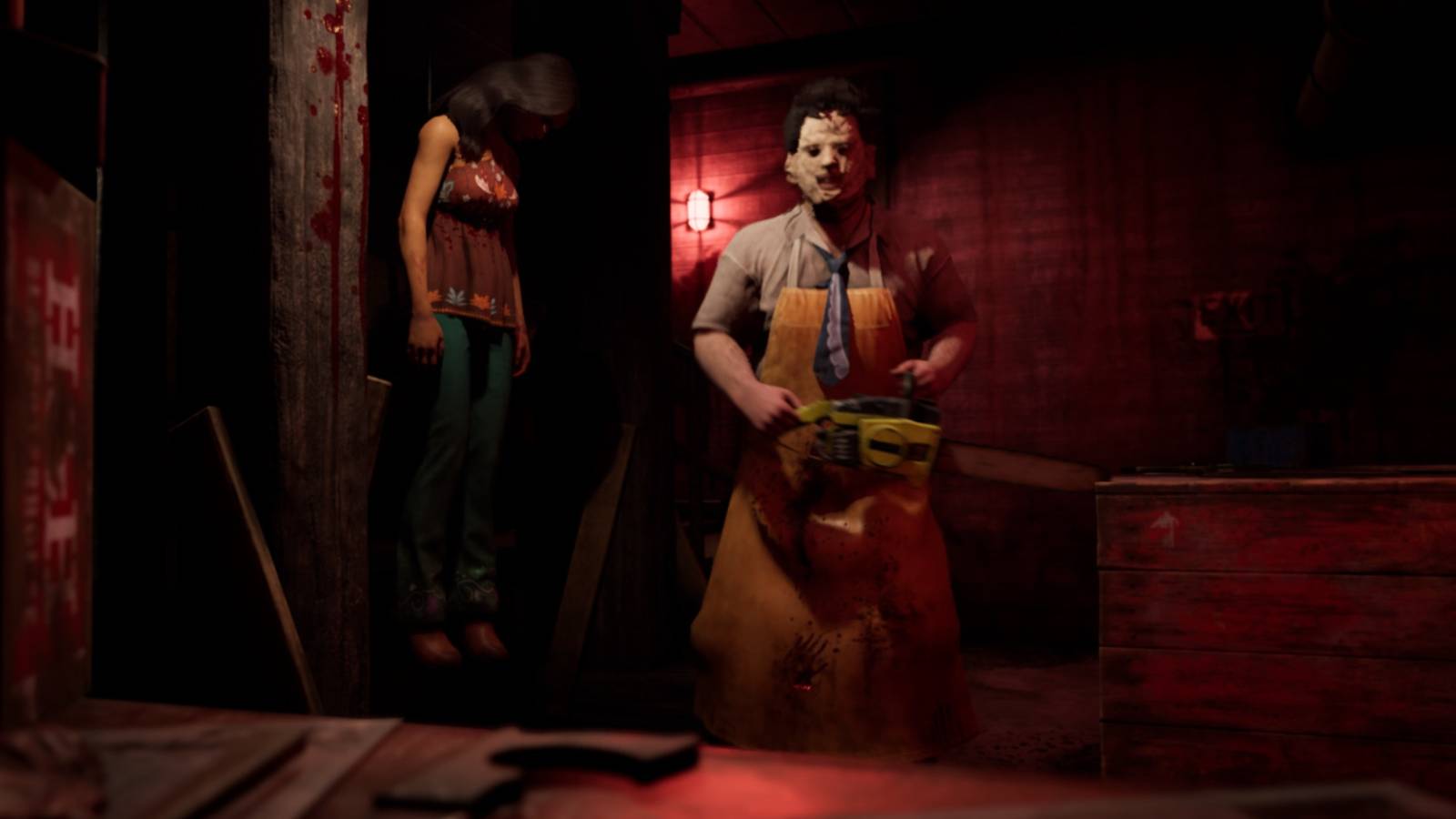 leatherface with his chainsaw, victim hung up
