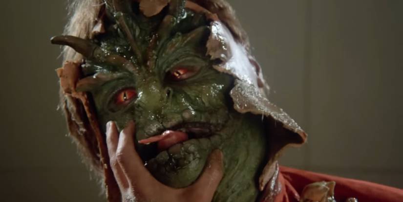 A Visitor is unmasked as a hideous reptilian alien in V: The Miniseries.