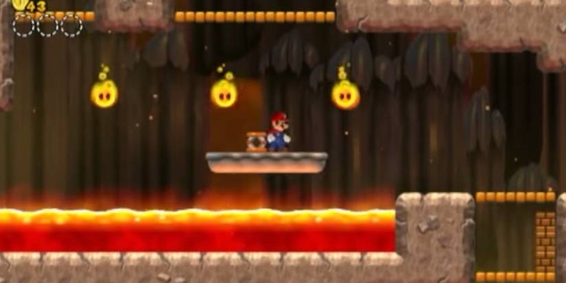mario standing on a platform above a lava lake in nsmb1