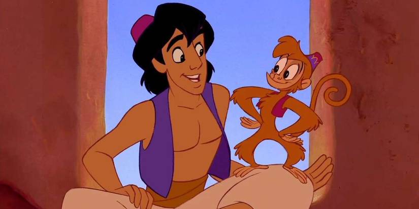 An image of Abu standing on Aladdin's lap during a conversation