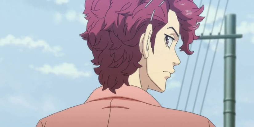 a boy with red hair turns his head