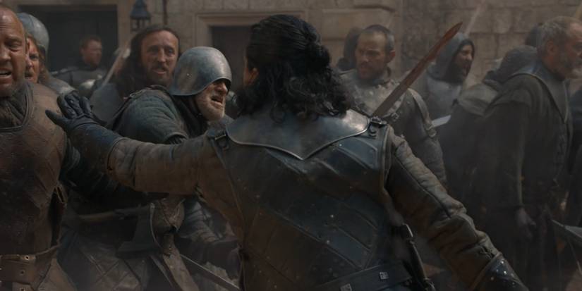 Jon Snow restrains the Northern army at King's Landing in Game of Thrones.