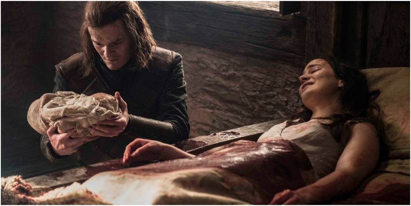 Ned Stark holding baby Jon Snow (Aegon Targaryen) beside Lyanna Stark in Game of Thrones.