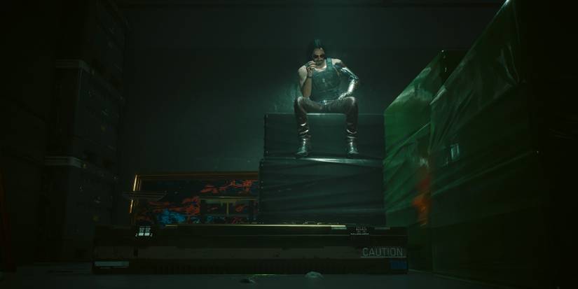 johnny silverhand sitting on a crate next to the john wick crate