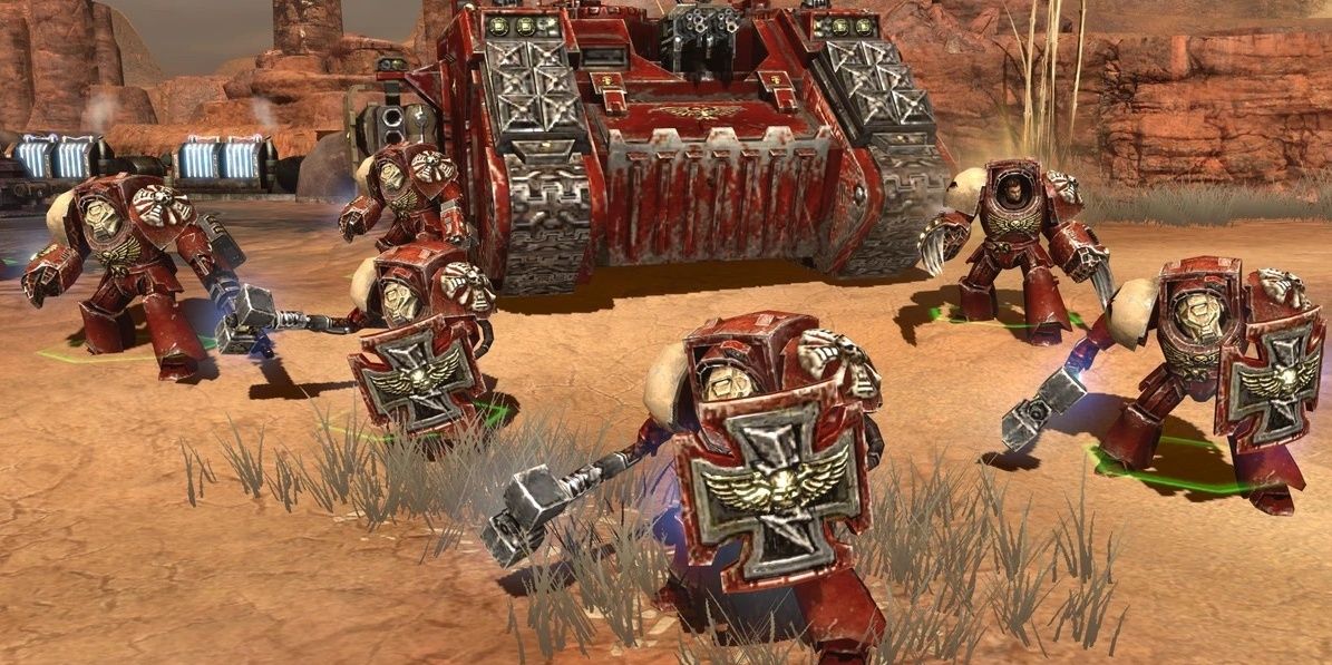 Four Terminators and a Force Commander in Terminator armor stand in front of a Land Raider