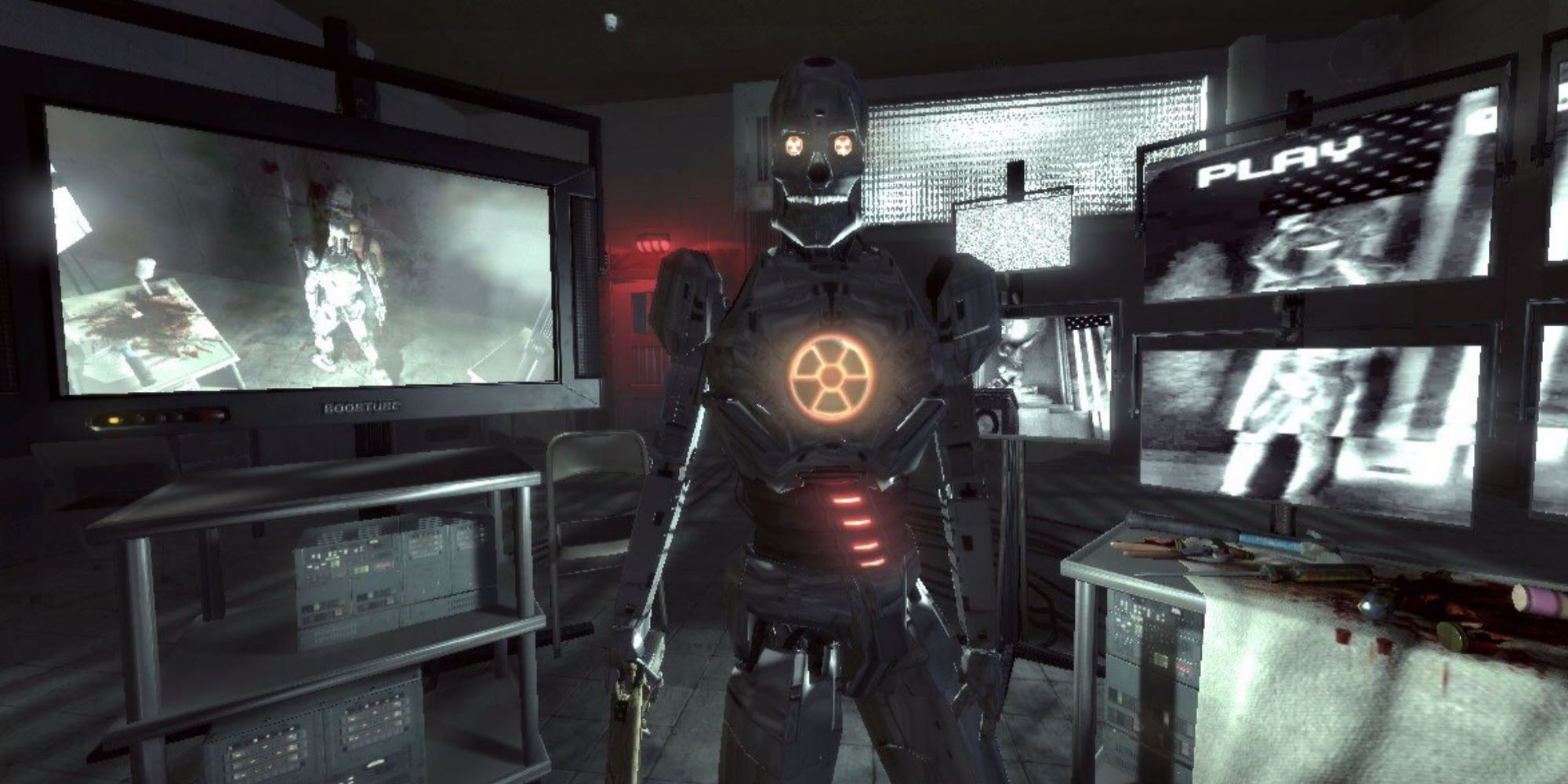 A robot facing the player in a torture room near TVs depicting Duke Nukem