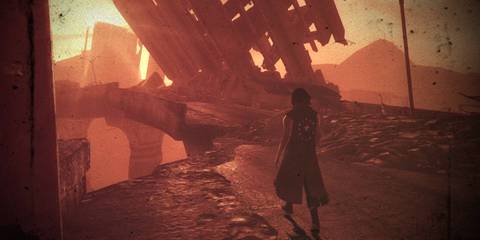 Person standing in a ruined city tinted with orange from the setting sun