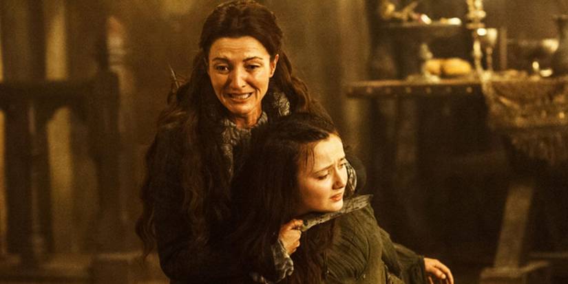 Catelyn Stark holds a knife to Walder Frey's wife in Game of Thrones.