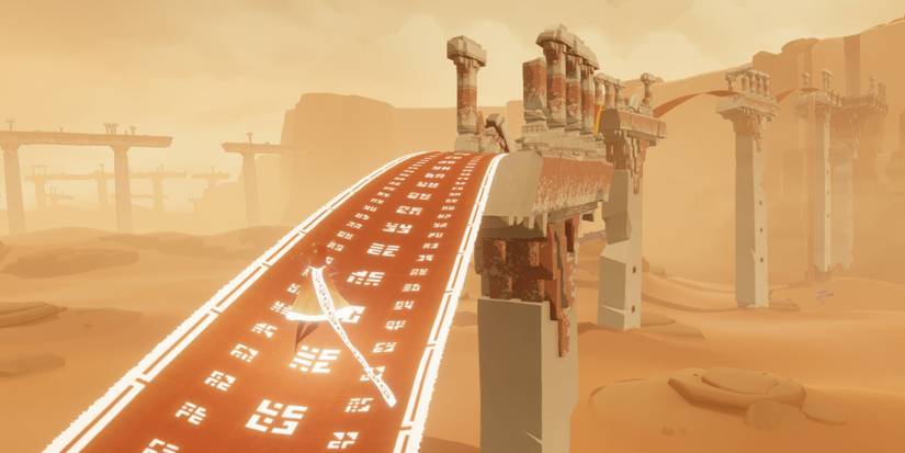 A robed figure with a glowing scarf floats across a glowing cloth bridge in Journey