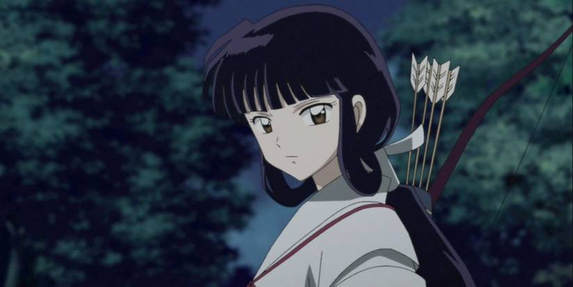 a girl with black hair, tied back, stands with a bow and arrow
