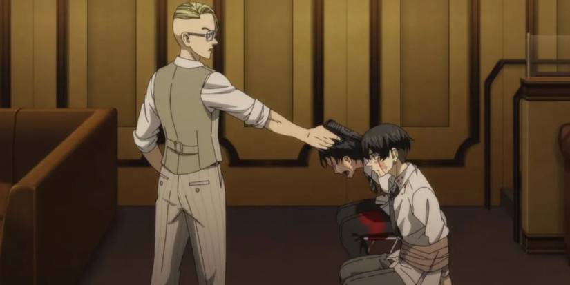 a man points a gun at  two men tied to chairs