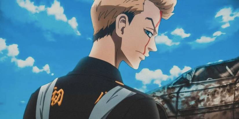 a man with blonde hair looks over his shoulder