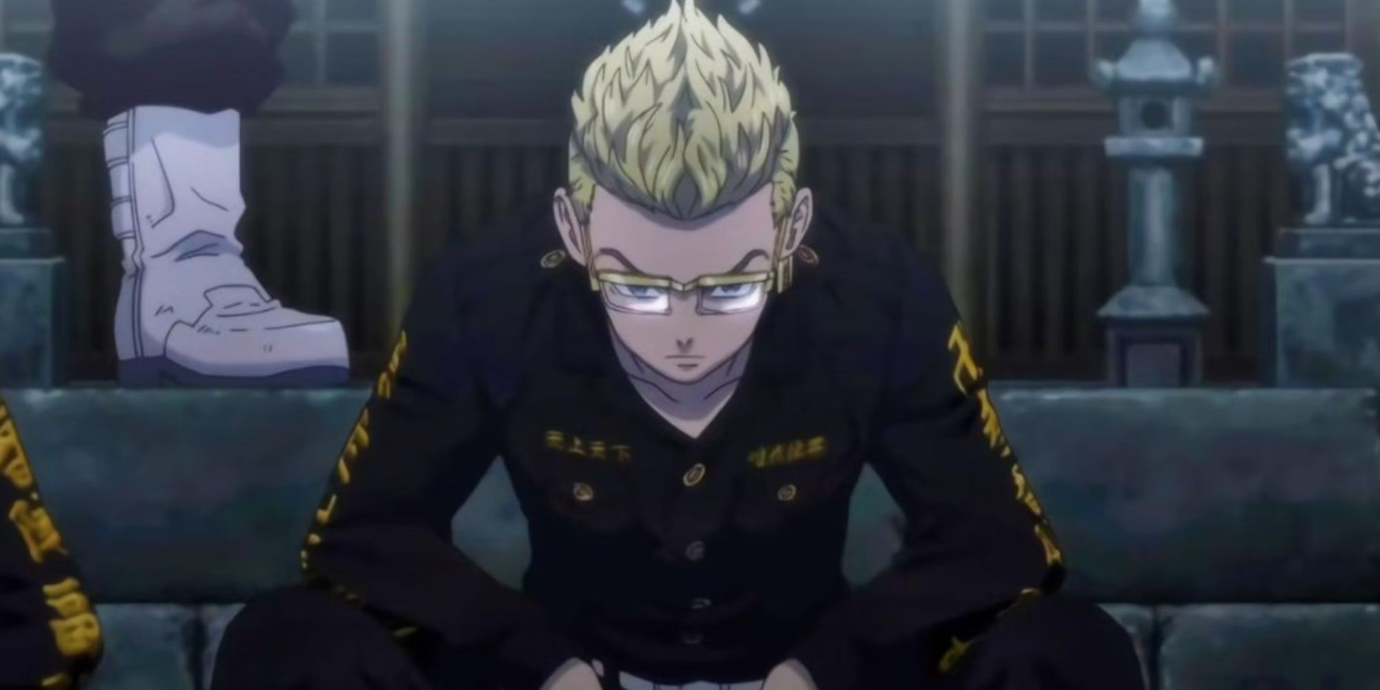 a boy with blonde hair sits in a gang uniform