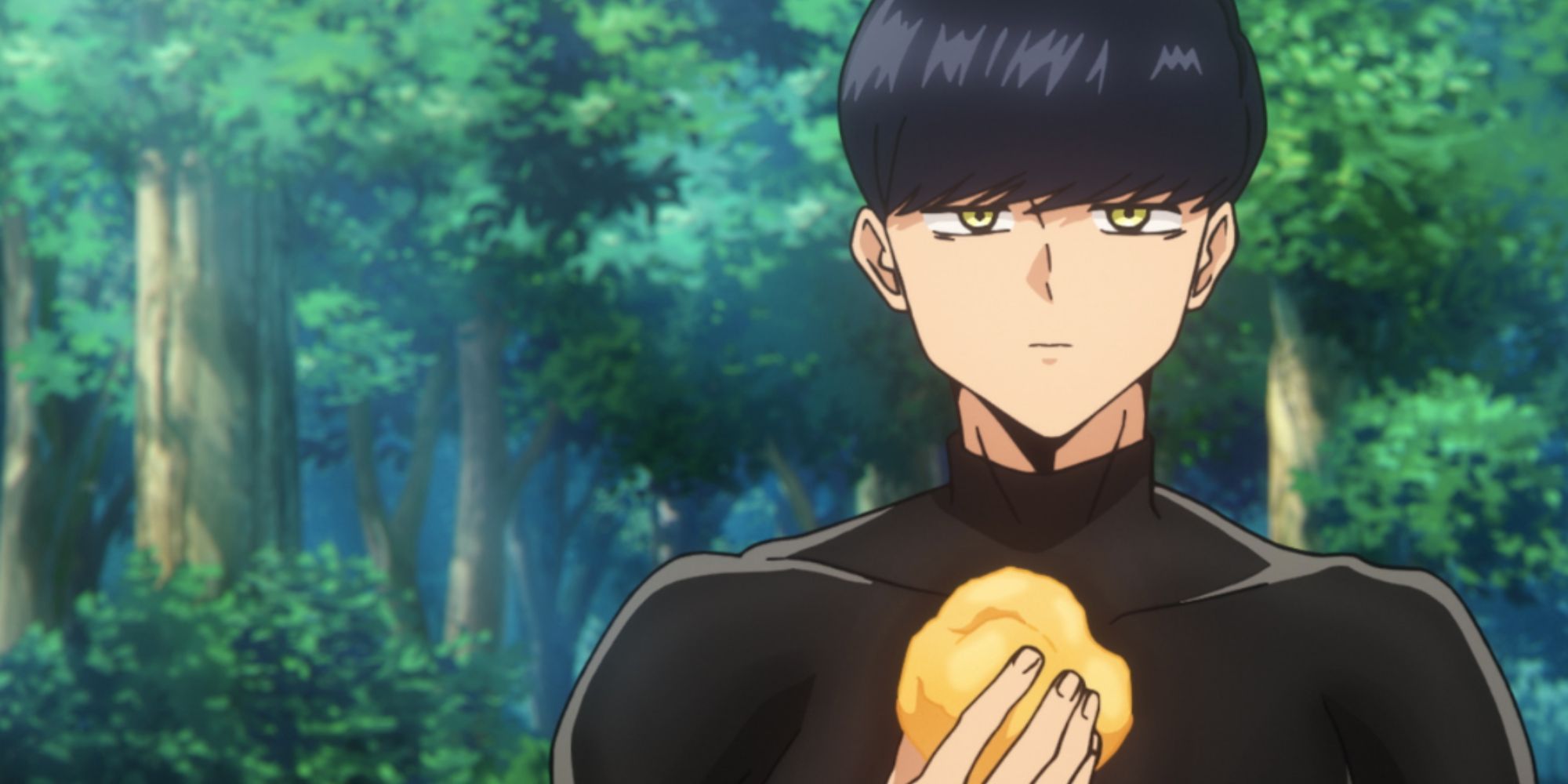 a boy with black hair eats a cream puff