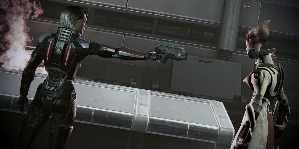 Shepard aiming her gun at Mordin
