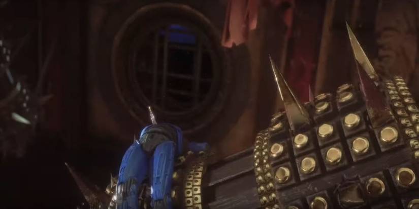 Robocop laying atop a giant club with spikes