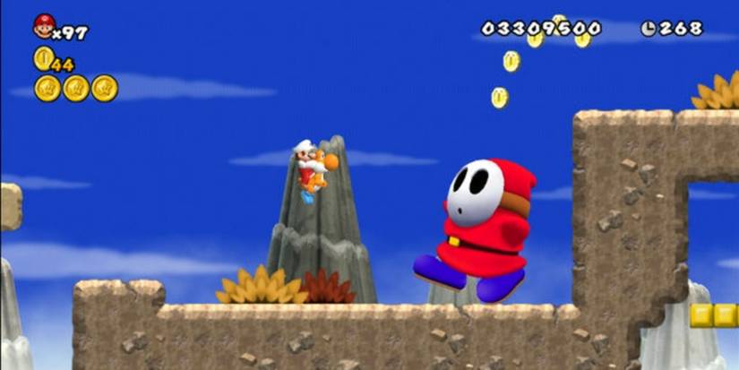 Mario on an orange Yoshi in front of a giant Shy Guy