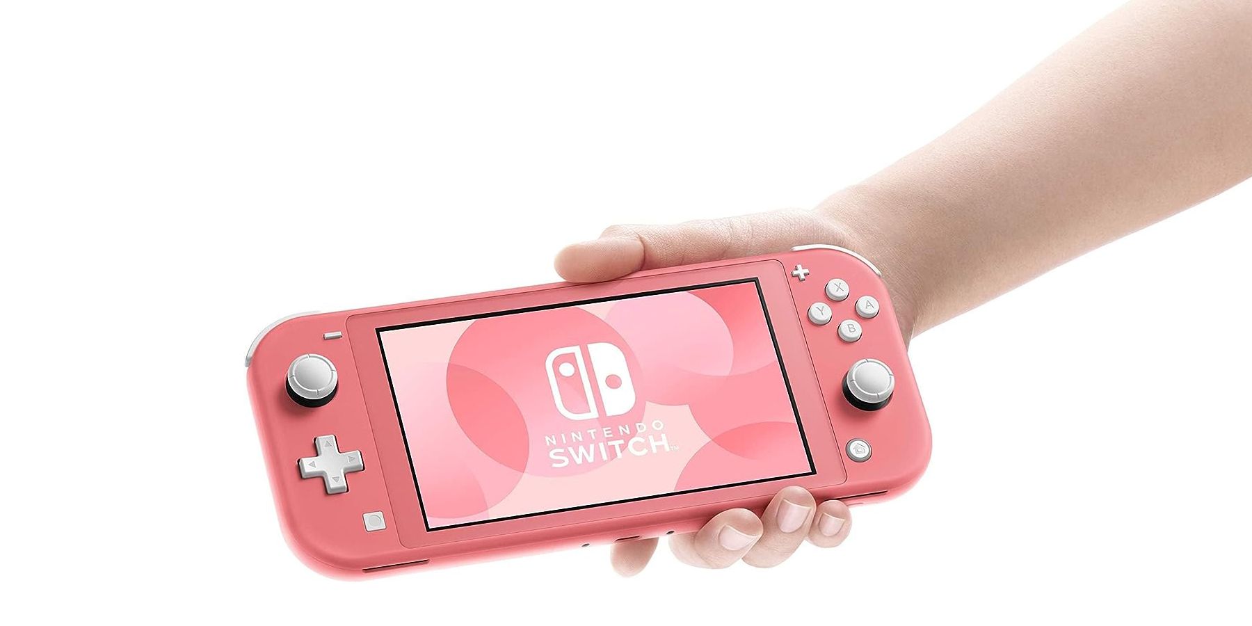 Nintendo Switch Lite Coral held in hand on white background