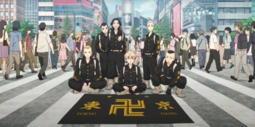 original toman members sit in front of flag