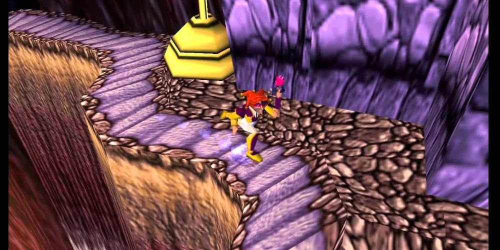 Player character Fargus runs along a winding path next to a deep chasm