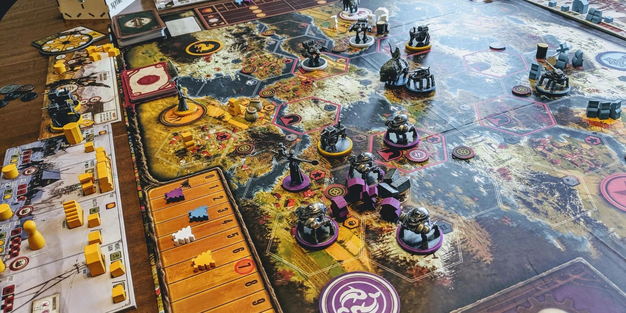 Scythe board game set up, featuring detailed miniatures of mechs and faction leaders on a map of alternate 1920s Europe.