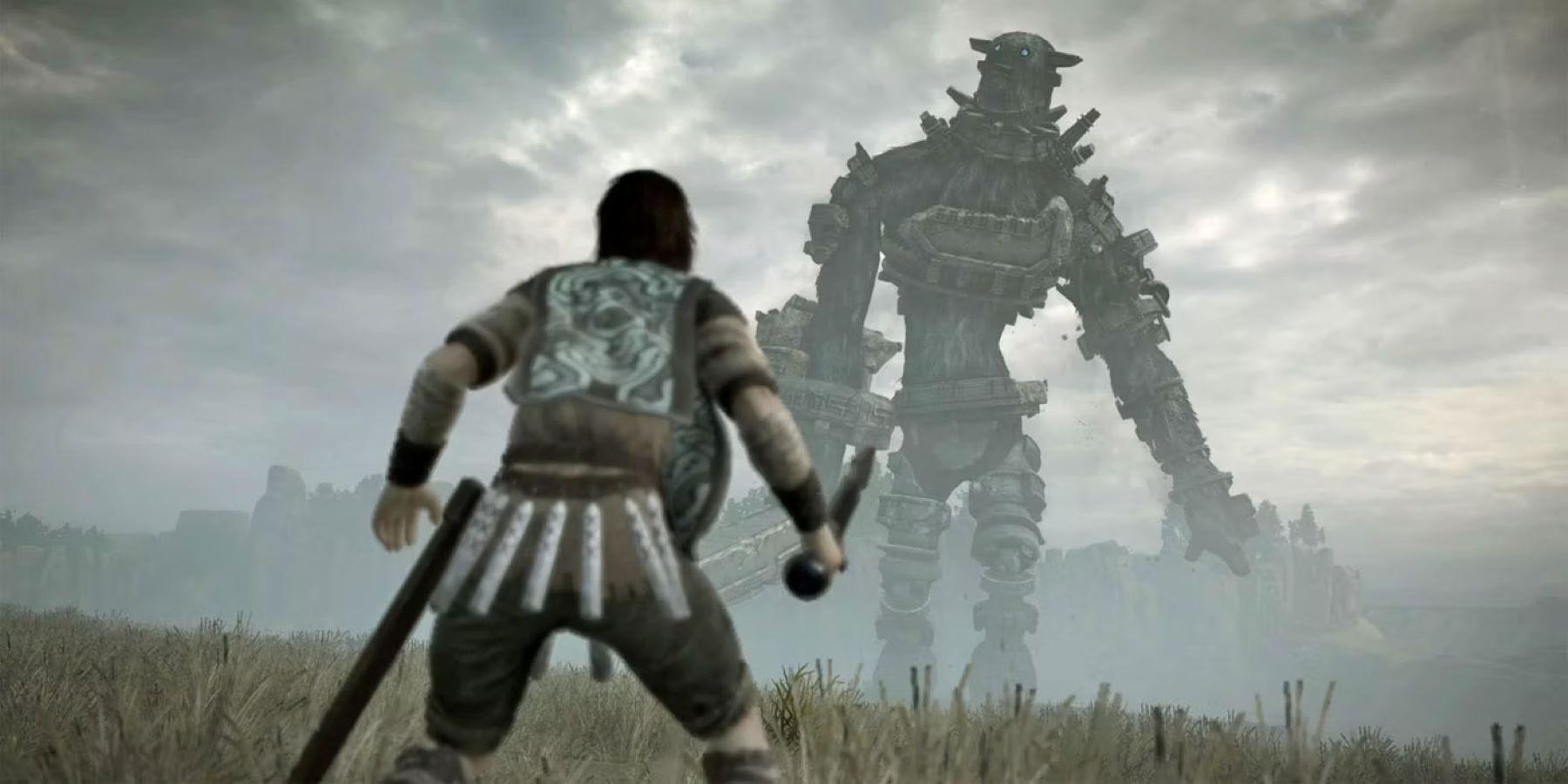 Wander confronting one of the colossi in Shadow of the Colossus