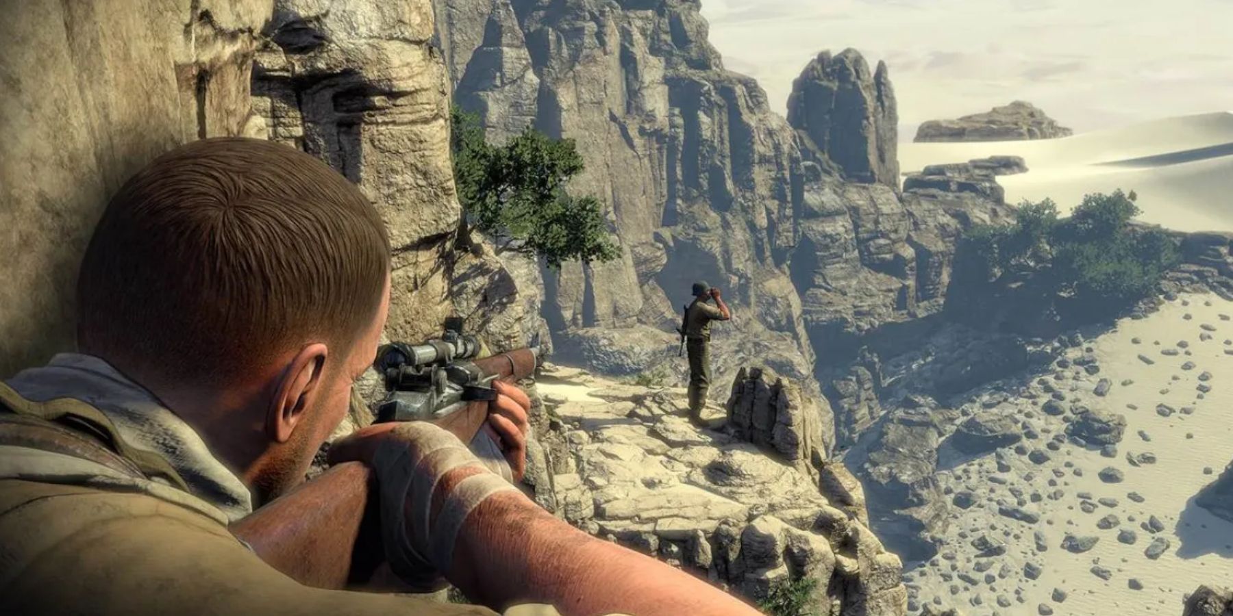 Sniper Elite 3 - using a sniper rifle ready to take down an enemy