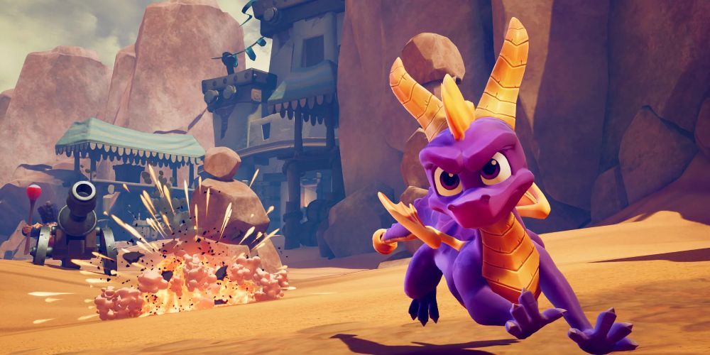 Spyro charged forward in a rocky area with a cannon firing at him from behind