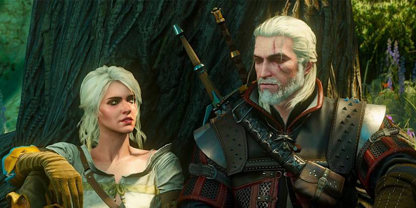 Siri and Gerald sitting by a tree