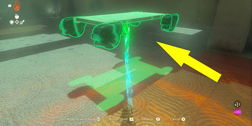 Link using Ultrahand on a car made of Zonai devices