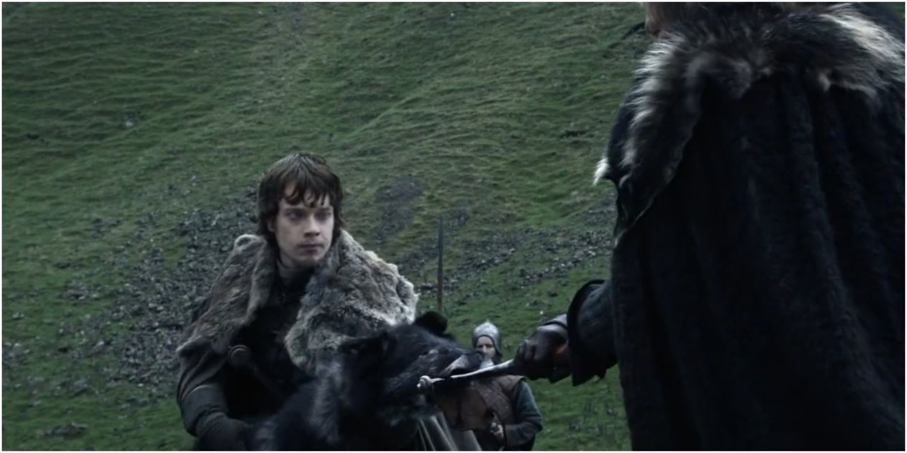 Theon Greyjoy holds the scabbard and Eddard draws Ice in Game of Thrones.