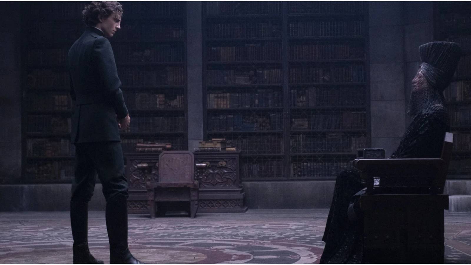 Paul Atreides stands before the Reverend Mother Gaius Helen Mohiam in Dune.