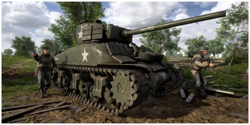 A tank surrounded by two soldiers in a clearing in the forest