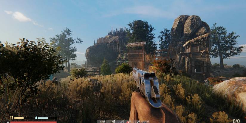 Holding a hand gun while looking at an enemy settlement Sunkenland