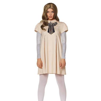The model is wearing a beige mid-length dress with a oversized black striped bow around the collar, with gray and white sleeves under the initial garment