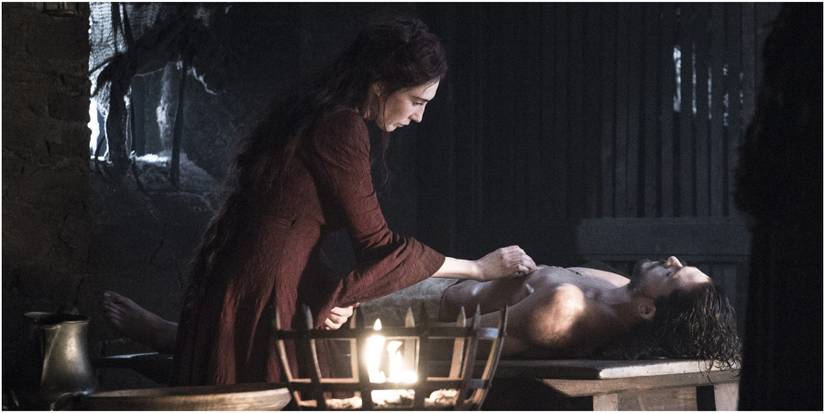 Melisandre tends to Jon Snow in Game of Thrones.