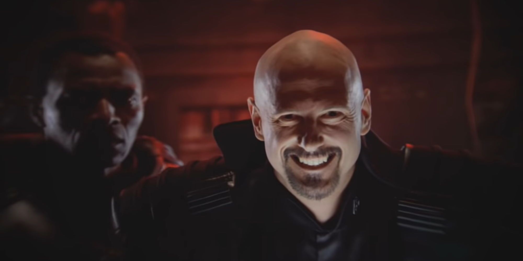 Kane laughing evilly while Brother Marcion watches in shock