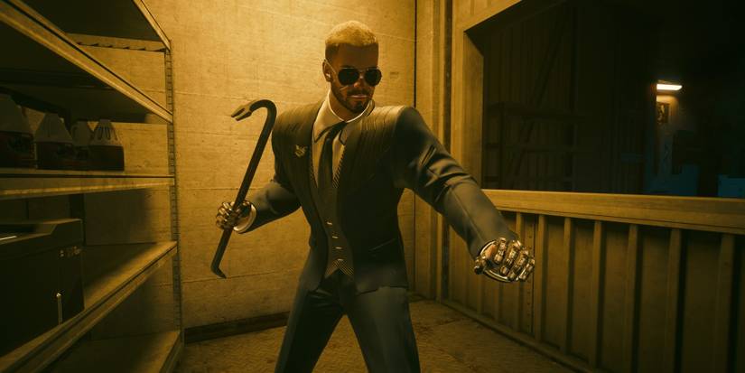 V wearing an FIA suit whilst holding a crowbar weapon
