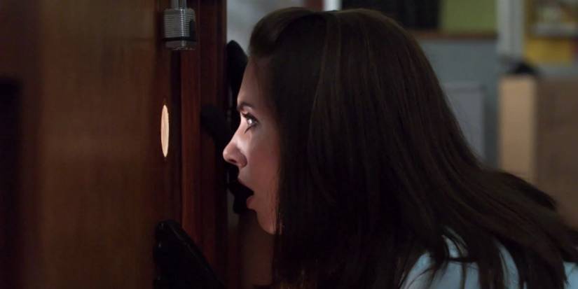 Annie looking through a peep hole