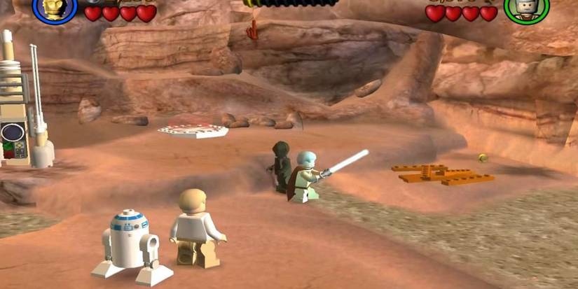 Luke Skywalker and R2D2 watch Ben Kenobi and a wounded protocol droid on Tatooine